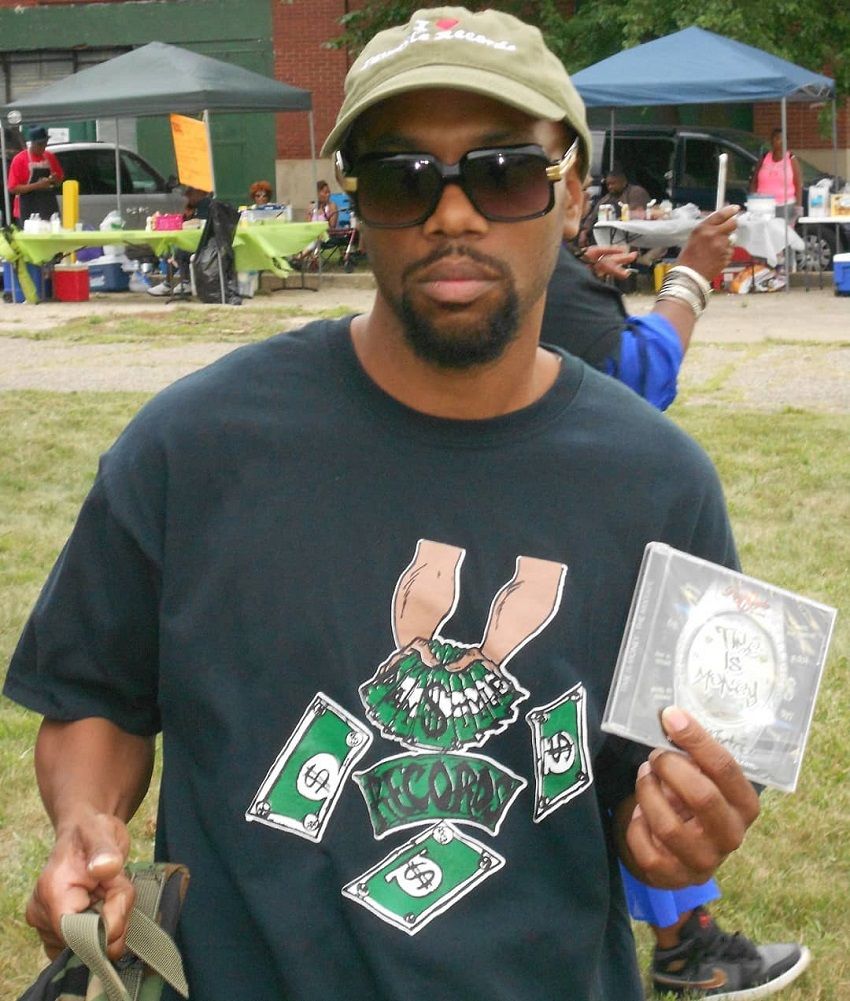 BK Paystyle selling cd's at a fundraiser in Highland Park, Mi wearing his Paystyle Records Time Is Money T-Shirt